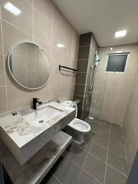 Bathroom features: marble countertop with integrated sink, round mirror, black wall-mounted faucet, glass shower enclosure, rain shower head, toilet, grey ceramic tile flooring, light grey wall tiles, black towel rack, window for natural light; style: modern.