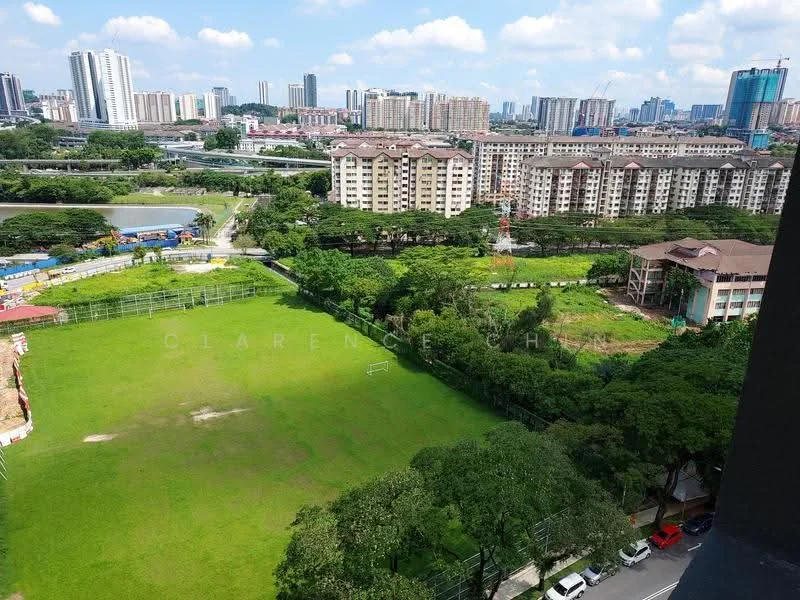 Exterior type: high-rise condominium; features: city skyline view, manicured lawn, surrounded by mature greenery, sports field, multi-storey buildings in background, open green space; style: modern.