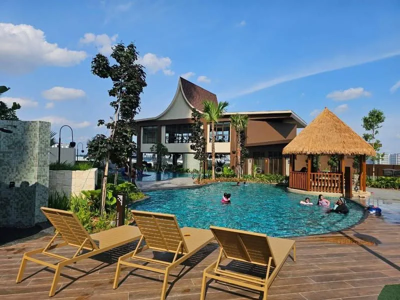 Exterior type: clubhouse; features: infinity pool, pool deck with loungers, thatched-roof gazebo, landscaped garden with palm trees, mature trees, water feature, modern architectural design, surrounded by greenery; style: modern.