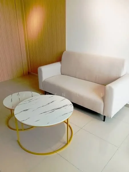 Living features: light beige fabric sofa, white marble coffee table with black veining, gold metal base for coffee table, light-colored tiled flooring, textured wall paneling in yellow, white painted walls, natural light from window, minimalist decor; style: modern.