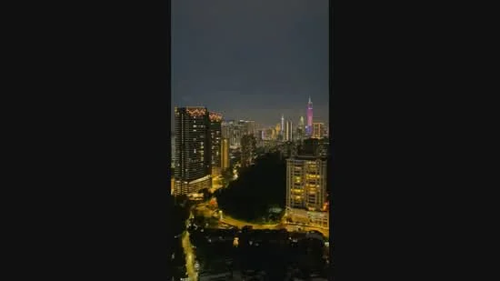Exterior type: high-rise condominium; features: city skyline view, night lighting, modern architecture, surrounded by urban landscape, visible high-rise buildings, illuminated towers; style: modern.