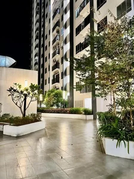 Exterior type: high-rise condominium; features: landscaped garden with plants, paved walkway, outdoor lighting, balconies on upper floors, glass curtain wall, white painted facade, manicured shrubs, trees in planters; style: modern.
