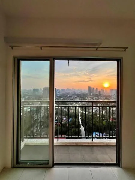 Room features: floor-to-ceiling sliding glass door, balcony with railing, city skyline view, sunset view, ceramic tile flooring, white painted walls; style: modern; view: city.