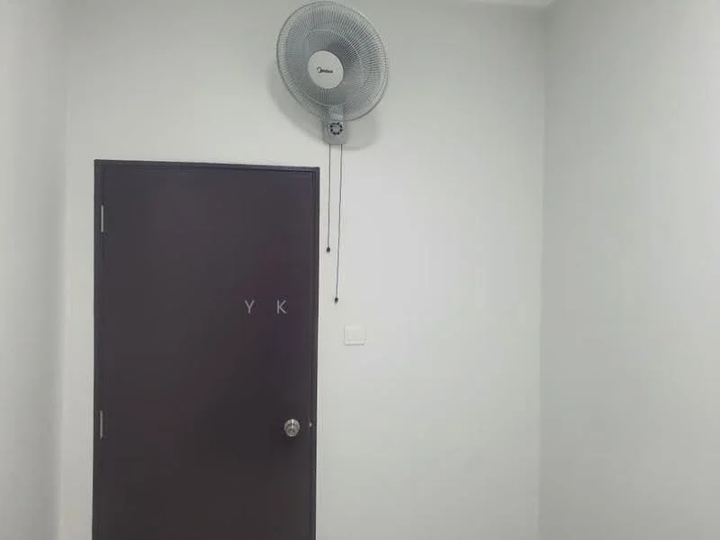 Room features: white painted walls, ceiling fan, brown door with knob, door with initials YK.