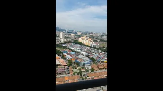 Exterior type: high-rise condominium; features: city skyline view, surrounded by residential buildings, urban landscape, visible rooftops of houses, commercial buildings in the distance, clear blue sky; style: modern.
