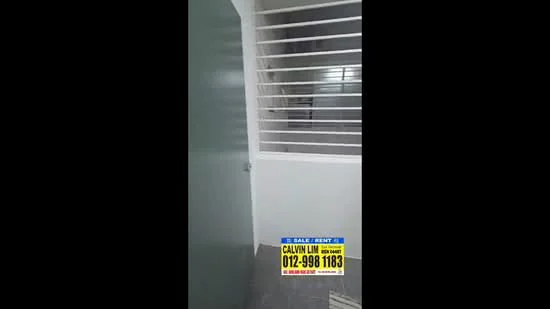 Room features: grey tiled flooring, white walls, metal security grille, green door, staircase visible in background.
