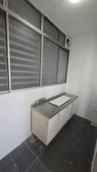 Laundry features: grey countertop, white cabinetry with doors, single-bowl sink, sliding glass windows, wall-mounted air conditioning unit, black tiled flooring, white painted walls, overhead lighting.
