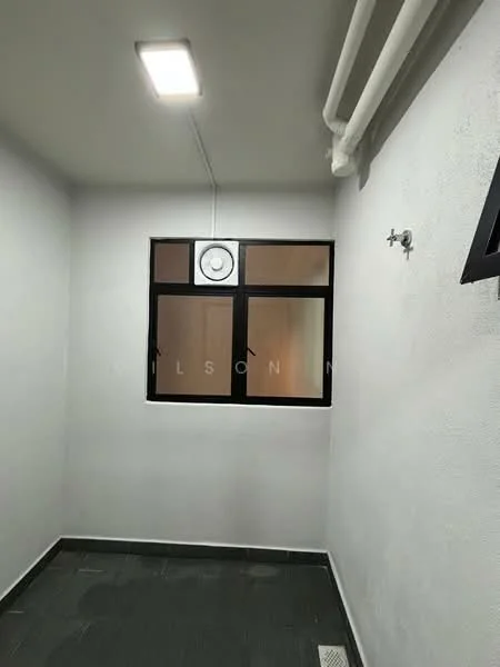 Room features: white painted walls, black framed window, clock on wall, ceiling light fixture, grey tile flooring, exposed pipes.