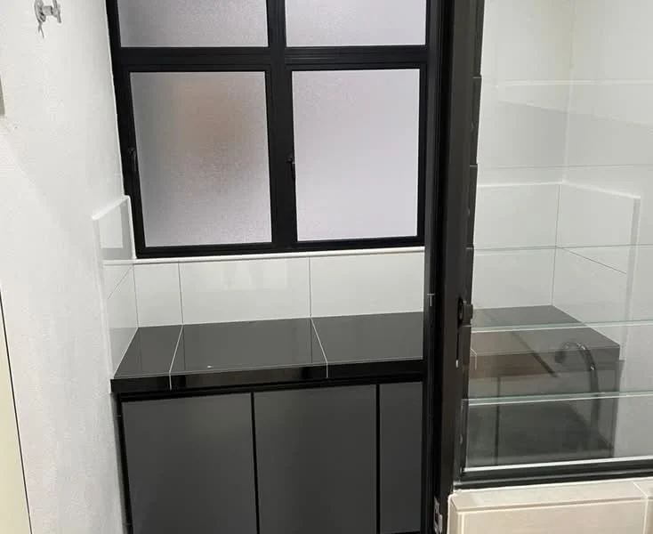 Room features: black cabinetry, black countertop, white tiled backsplash, frosted glass window, sliding glass door, built-in shelving, white walls, tile flooring; style: modern.