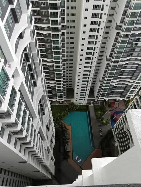Exterior type: high-rise condominium; features: glass curtain wall, white painted facade, recessed balconies, infinity pool, pool deck with loungers, children's playground, landscaped garden, surrounded by mature greenery; style: modern.