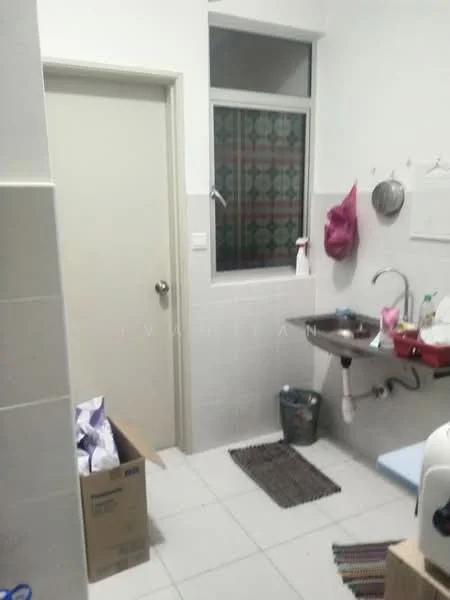 Laundry features: white painted walls, grey tiled flooring, single-bowl stainless-steel sink, wall-mounted faucet, window with patterned treatment, plastic storage bin, cardboard box, small area rug, plastic bottle, cleaning supplies, utility shelf, door to adjacent room.