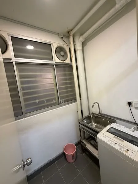 Laundry features: single-bowl stainless-steel sink, chrome faucet, front-load washing machine, grey tiled flooring, white painted walls, window with louvered glass, exposed plumbing, metal shelving unit.