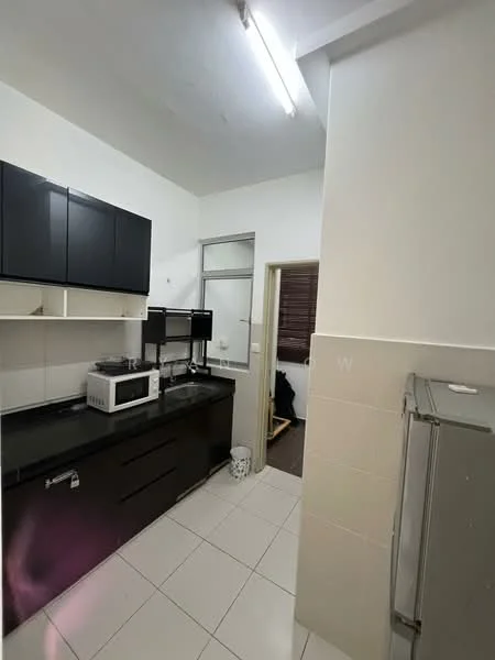 Kitchen features: black cabinetry, white tiled walls, black countertop, stainless-steel fridge, microwave, built-in cabinets, white ceramic tile flooring, fluorescent ceiling lights; style: modern. Room features: doorway leading to another room.