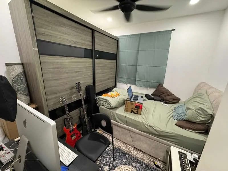 Bedroom features: queen-size bed with beige bedding, upholstered headboard, built-in wardrobe with sliding doors, black office chair, computer desk with monitor, guitar, acoustic guitar, area rug with intricate pattern, ceiling fan, green curtain, wall-mounted light, decorative pillows; style: modern.