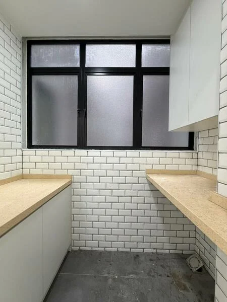 Kitchen features: white subway tile backsplash, light-colored stone countertop, white cabinetry, grey tile flooring, black-framed windows, two countertop sections, no visible appliances, minimalist design; style: modern.