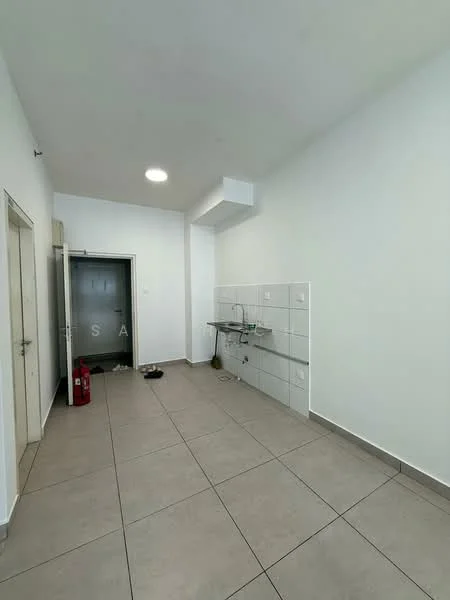 Room features: white painted walls, grey tiled flooring, single-bowl stainless-steel sink, wall-mounted faucet, countertop with tile backsplash, ceiling light, fire extinguisher, door leading to hallway, empty space, no visible appliances; style: modern.