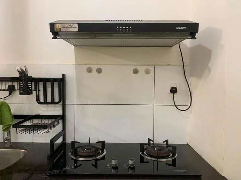 Kitchen features: black glass cooktop with two burners, stainless-steel range hood, white tiled backsplash, black countertop, wall-mounted power outlet, metal wall rack for utensils, green kitchen towel, shelf for storage; style: modern.