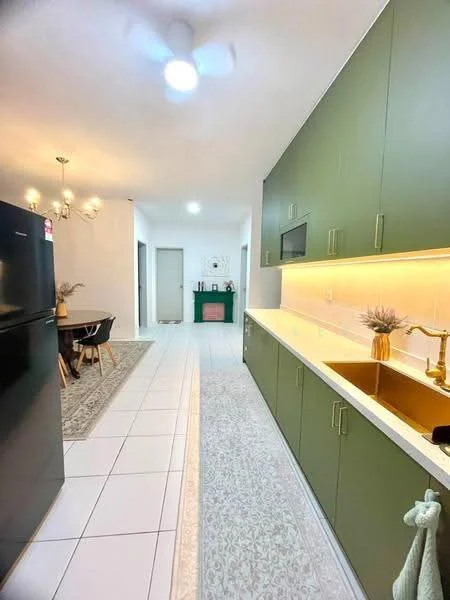 Kitchen features: green cabinetry, white countertop, single-bowl stainless-steel sink, gold gooseneck faucet, white tile backsplash, recessed LED downlights, pendant lighting, fridge, tile flooring, area rug, open layout to dining area; style: modern. Dining features: dining table, wooden chairs; style: modern.