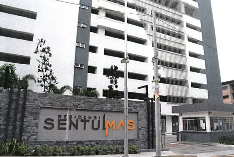 Exterior type: high-rise condominium; features: white painted facade, glass curtain wall, stone cladding at entrance, security guard house, landscaped entrance, multiple balconies, visible parking area, modern signage, surrounded by greenery; style: modern.