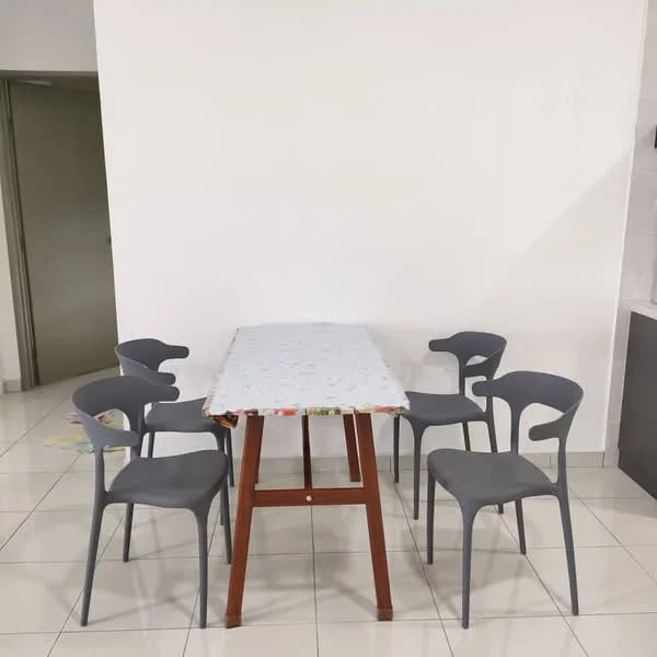 Dining features: rectangular dining table with wooden legs, tabletop with patterned tablecloth, 5 grey plastic dining chairs, white painted walls, glossy tile flooring, open space, neutral color scheme; style: modern.