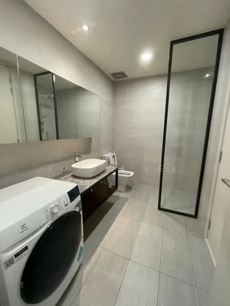 Bathroom features: single-sink vanity with wood cabinet, large mirror, shower with glass enclosure, toilet, washing machine, grey tiled walls, grey tiled flooring, recessed downlights; style: modern.