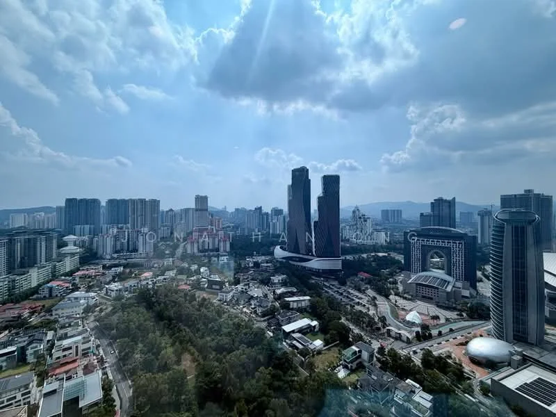 Exterior type: high-rise condominium; features: city skyline view, surrounded by urban landscape, multiple high-rise buildings, greenery in foreground, cloudy sky, sunlight breaking through clouds; style: modern.