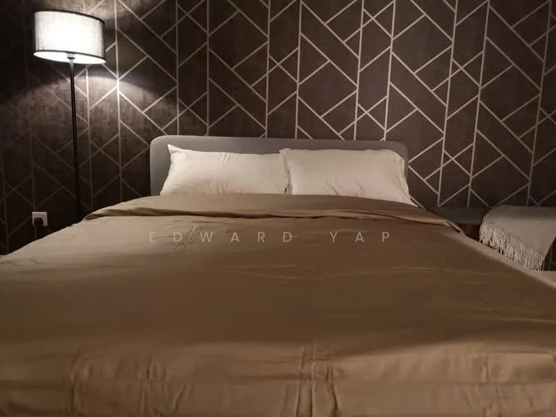 Bedroom features: king-size bed with beige bedding, upholstered headboard, decorative throw blanket, two white pillows, geometric patterned feature wall in dark tones, floor lamp with a fabric shade, nightstand with decorative fringe, wooden flooring; style: modern.