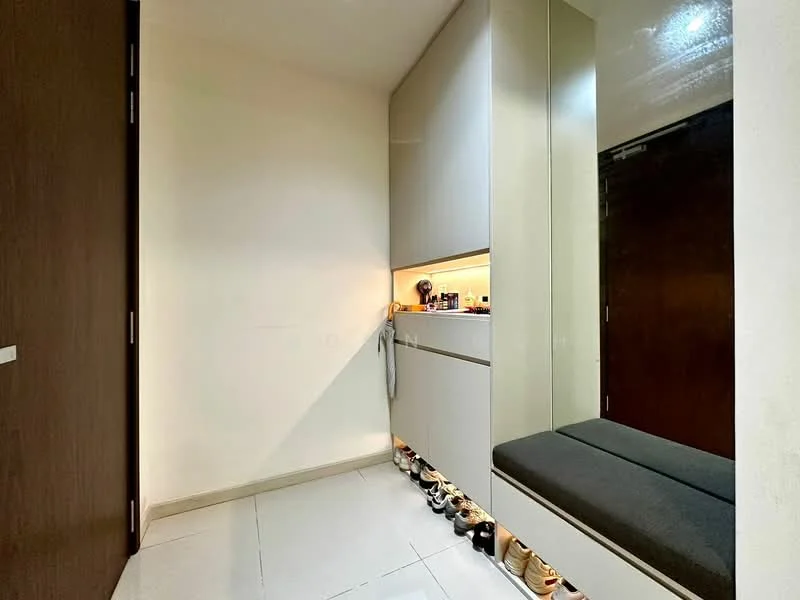 Room features: white painted walls, grey built-in cabinetry, grey upholstered bench, tile flooring, ambient lighting under cabinetry, shoe storage area, mirror on wall, door leading to another room; style: modern.