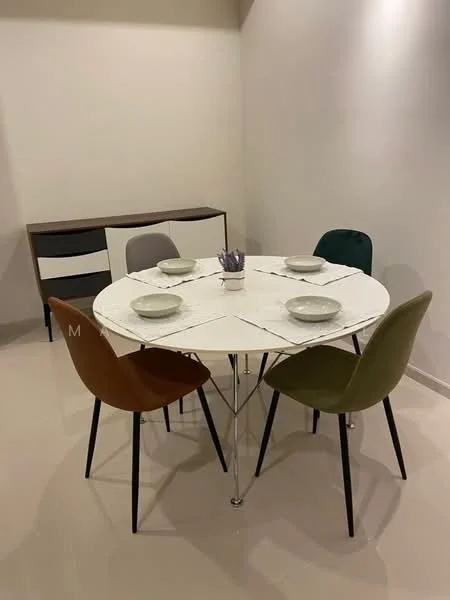Dining features: round marble dining table, 4 dining chairs in various colors (brown, green, grey, and beige), white walls, light-colored flooring, minimalist sideboard, decorative table setting with plates and utensils; style: modern.