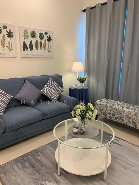 Living features: blue fabric sofa with decorative cushions, glass coffee table with circular top, area rug with geometric pattern, floor lamp with white shade, blue side table, decorative plant on side table, framed botanical artwork on wall, curtains in grey fabric; style: modern.