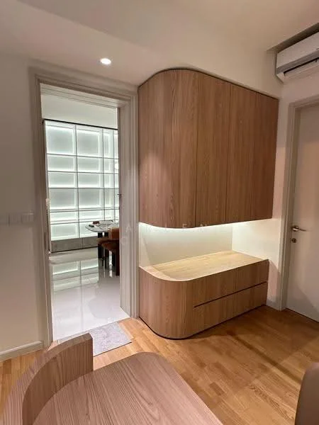 Room features: wood cabinetry, built-in storage unit, light wood finish, curved edges on cabinetry, recessed lighting, white walls, wooden flooring, open layout, air conditioning unit; style: modern.