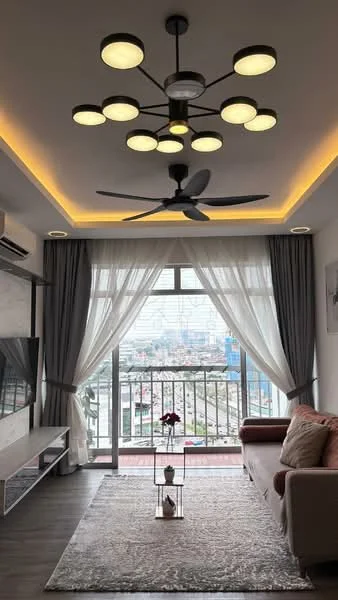 Living features: 3-seater fabric sofa in beige, area rug with geometric pattern, wall-mounted TV, TV console, 5-blade ceiling fan with integrated LED light, recessed downlights, floor-to-ceiling windows, sheer curtains, grey curtains, balcony view, decorative vase with flowers, wooden flooring, accent wall with artwork; style: modern; view: city.