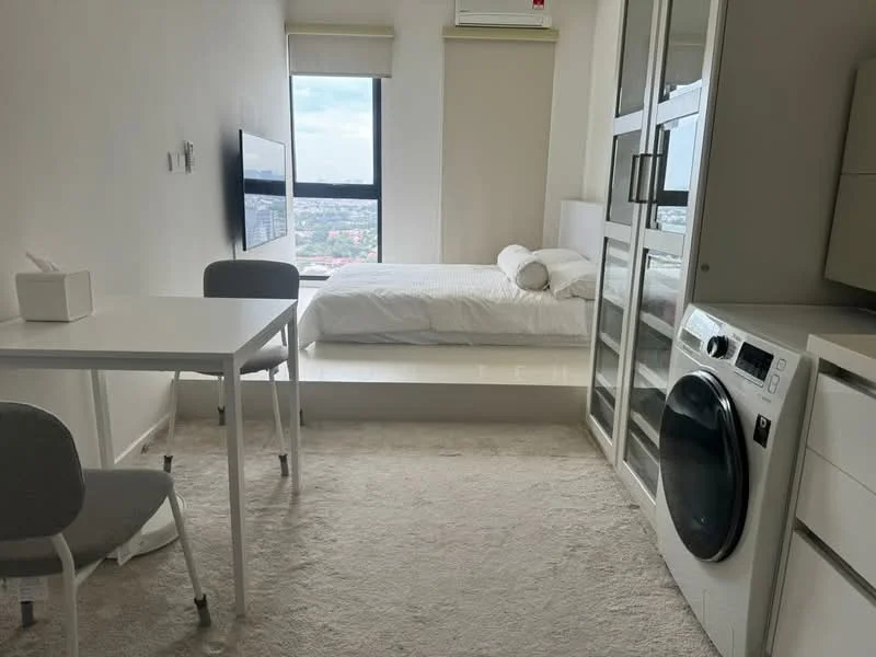 Bedroom features: queen-size bed with white bedding, floor-to-ceiling window with city view, white painted walls, light-colored carpet flooring, mounted TV on wall, white desk with two chairs, built-in wardrobe with glass doors, front-load washing machine, air conditioning unit, shelf unit with glass panels; style: modern; view: city.