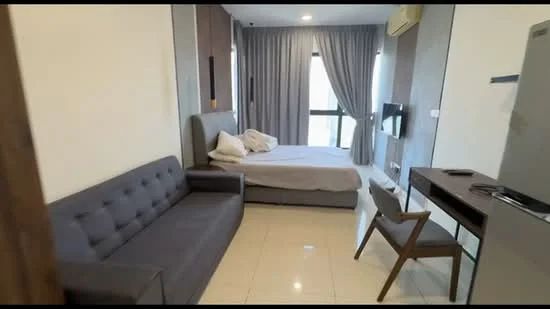 Room features: grey fabric sofa, queen-size bed with light bedding, wooden study desk, wooden chair, wall-mounted TV, floor-to-ceiling windows, curtains, air conditioning unit, polished tile flooring, light-colored walls, decorative wall paneling; style: modern.