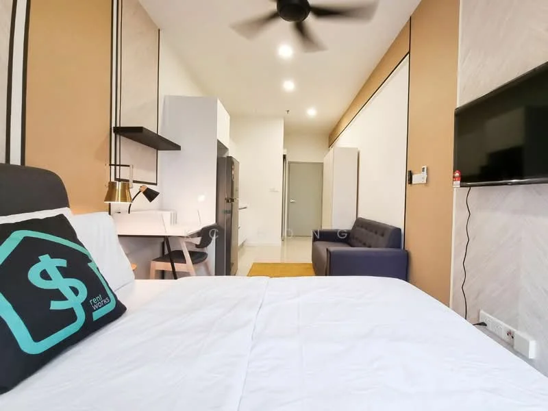 Room features: queen-size bed with white bedding, black upholstered headboard, ceiling fan, wall-mounted TV, sofa in dark blue, desk with chair, kitchenette with black cabinetry, white countertop, refrigerator, light fixtures, neutral wall colors, laminate flooring, area rug, decorative wall paneling; style: modern.