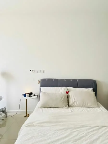 Bedroom features: queen-size bed, upholstered headboard in grey, white bedding, two decorative pillows, nightstand with gold finish, table lamp, wall-mounted light switch, plain white walls, glossy tile flooring; style: modern.