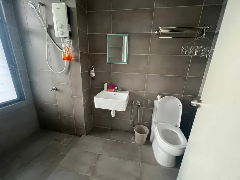 Bathroom features: grey ceramic tile flooring, grey tiled walls, white wall-mounted sink, chrome basin mixer faucet, one-piece toilet, mirror above sink, shower with wall-mounted showerhead, water heater unit, towel rack, window for natural light; style: modern.