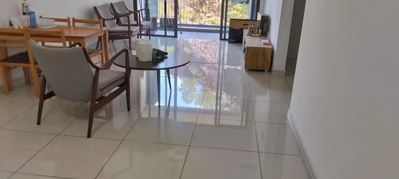 Living features: glossy ceramic tile flooring, white painted walls, floor-to-ceiling windows, wooden coffee table, 2 wooden chairs, TV console, decorative items on console, natural light from windows; style: modern; view: garden.