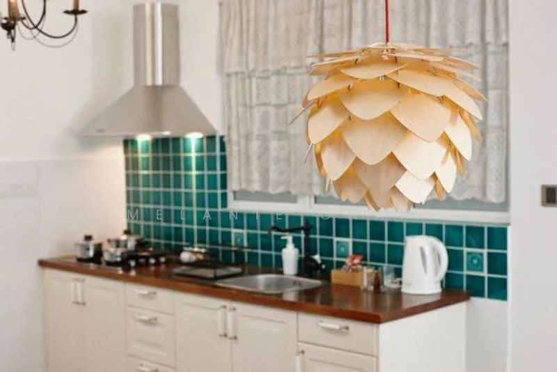 Kitchen features: white cabinetry, wood countertop, stainless-steel sink, chrome pull-down faucet, built-in stainless-steel range hood, 4-burner gas hob, green tiled backsplash, kettle, decorative pendant light, window with lace curtains; style: modern.