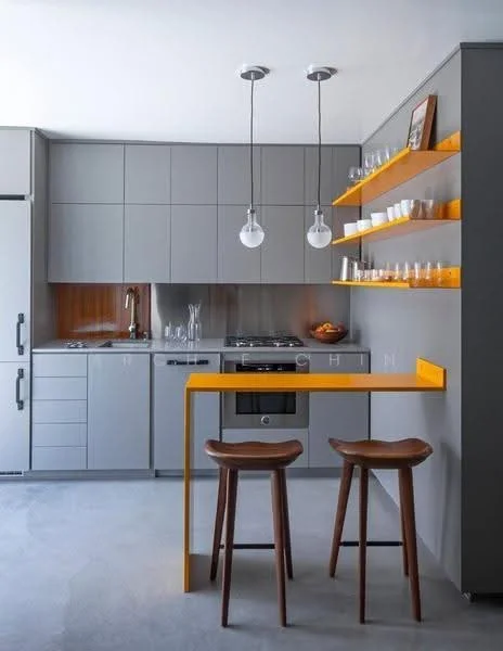 Kitchen features: grey cabinetry with flat-panel doors, orange accent shelf, stainless-steel fridge, stainless-steel oven, 4-burner gas hob, single-bowl stainless-steel sink, chrome pull-down faucet, pendant lighting with glass bulbs, bar counter with orange accent, two wooden bar stools, open shelving with glassware, wooden backsplash, concrete flooring; style: modern.