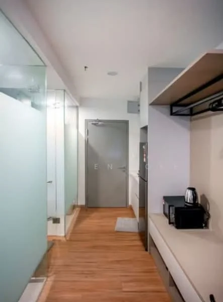 Room features: wooden flooring, glass partition wall, grey painted walls, recessed lighting, built-in shelf, kitchenette with countertop, microwave, coffee maker, door to hallway, frosted glass door, wall-mounted cabinet; style: modern.