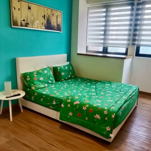 Bedroom features: green floral bedspread, white upholstered bed frame, wooden flooring, turquoise painted walls, two large windows with horizontal blinds, nightstand with lamp, framed artwork on wall; style: modern.