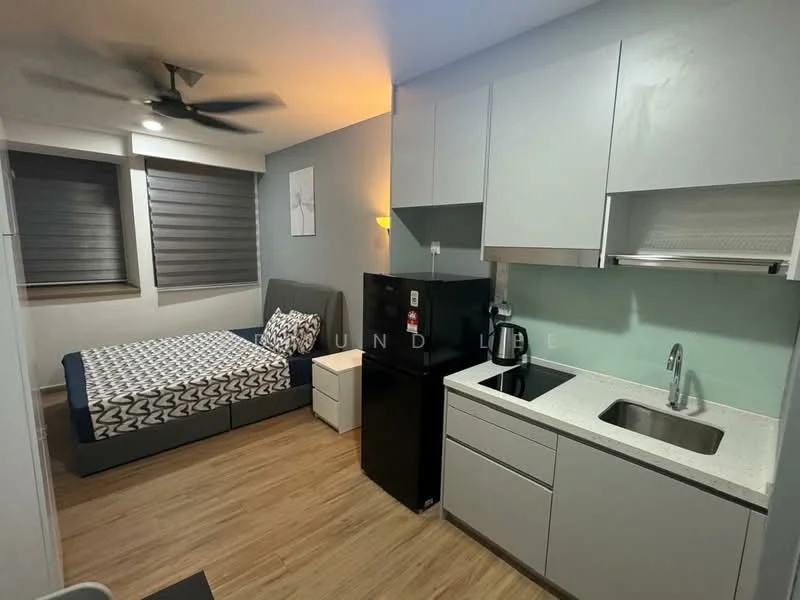 Room features: queen-size bed, upholstered headboard, 2 bedside tables, black fridge, single-bowl stainless-steel sink, chrome pull-down faucet, white quartz countertop, grey cabinetry, wood laminate flooring, ceiling fan with light, roller blinds on windows, wall-mounted artwork; style: modern.