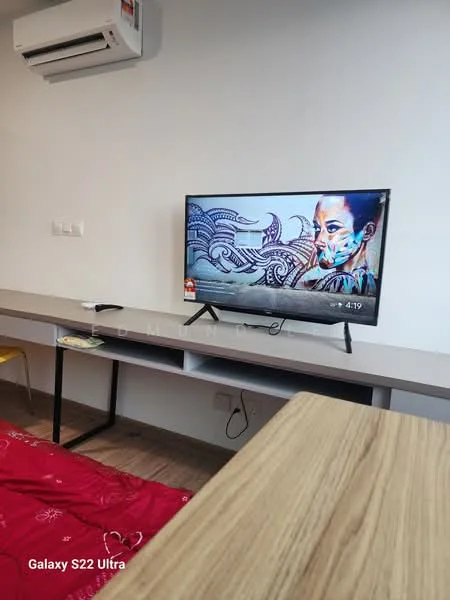Room features: wall-mounted TV, wooden TV console, decorative artwork on TV screen, air conditioning unit, bed with red bedding, wooden flooring, light-colored walls, shelf or table surface; style: modern.