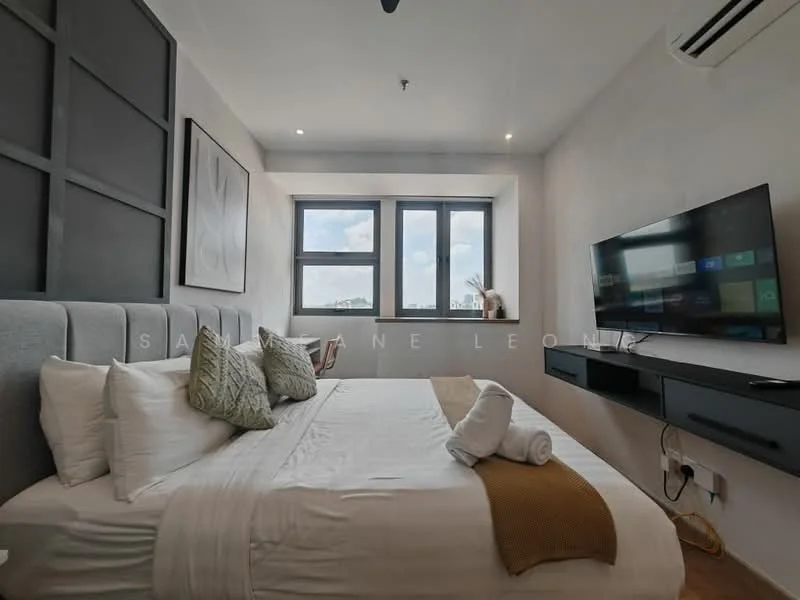 Bedroom features: king-size bed, upholstered headboard, white bedding with decorative pillows, wall-mounted TV, floating media console, two windows with black frames, air conditioning unit, light-colored walls, wooden flooring, decorative artwork on wall, bedside towels; style: modern; view: city.