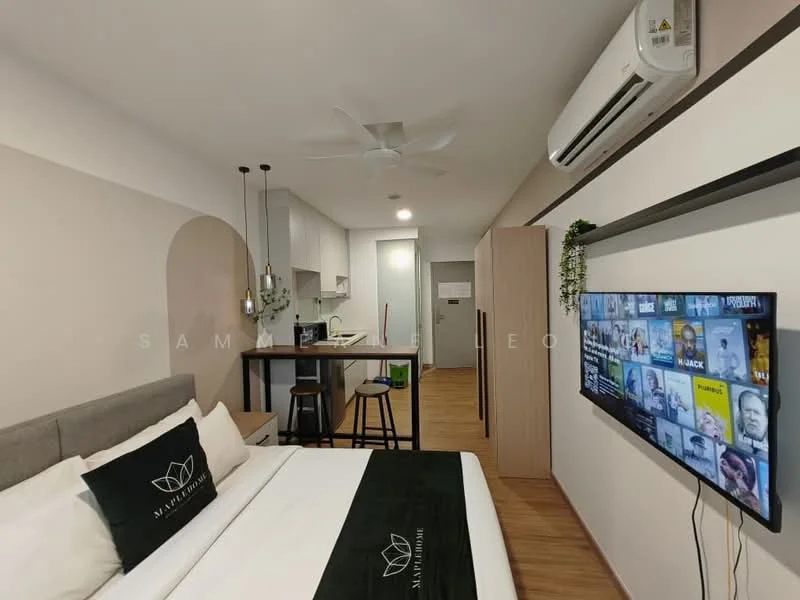 Room features: queen-size bed with grey upholstered headboard, white bedding with black accent throw, wall-mounted TV, wooden flooring, 5-blade ceiling fan, air conditioning unit, kitchenette with white cabinetry, stainless-steel sink, chrome pull-down faucet, bar counter with two stools, refrigerator, microwave, light-colored walls, decorative wall art; style: modern.