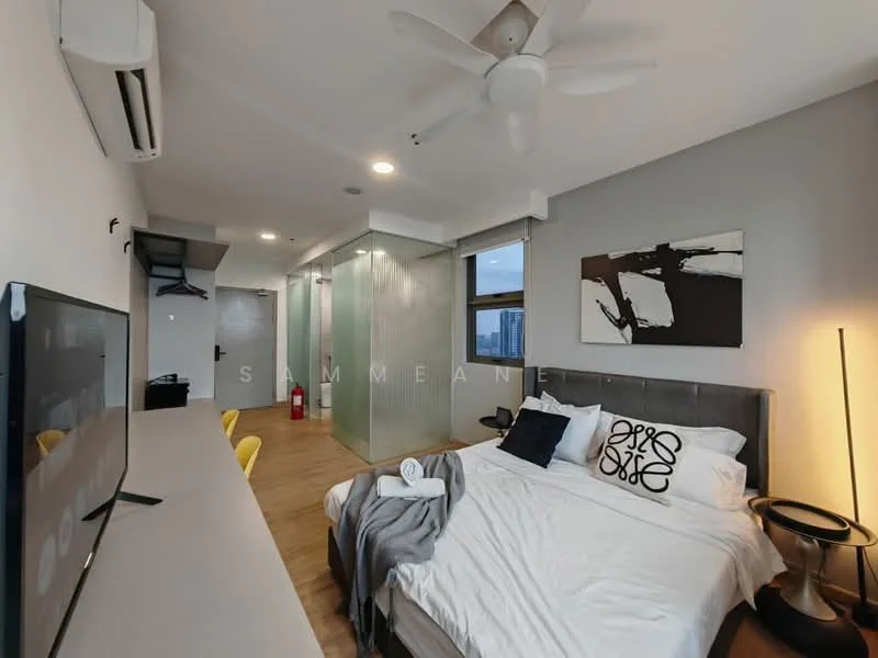 Bedroom features: king-size bed with grey upholstered headboard, white bedding with decorative pillows, 2 bedside lamps with black shades, wooden flooring, 5-blade ceiling fan, wall-mounted TV, desk with chair, floor-to-ceiling windows, air conditioning unit, decorative artwork on wall, open closet space, glass partition to bathroom; style: modern; view: city.