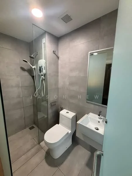 Bathroom features: grey tiled walls, grey tiled flooring, walk-in shower with glass enclosure, rain shower head, handheld shower, toilet with modern design, single-sink vanity with wall-mounted faucet, framed mirror, exhaust fan, shower heater, chrome towel rail; style: modern.