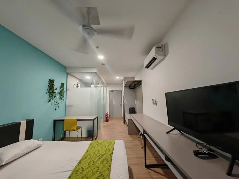 Bedroom features: queen-size bed with white bedding, green accent throw blanket, wooden flooring, light blue accent wall, white painted walls, 5-blade ceiling fan, wall-mounted air conditioning unit, large flat-screen TV on console, wooden console table, yellow dining chair, glass partition wall, built-in wardrobe, fire extinguisher visible; style: modern.
