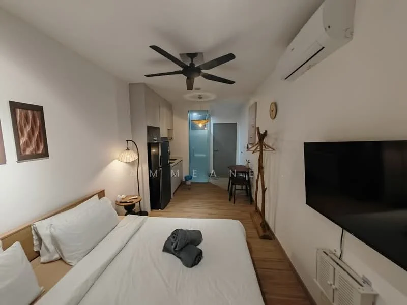 Bedroom features: queen-size bed, upholstered headboard, white bedding, 2 grey towels, wooden bedside table, table lamp, wall-mounted TV, 5-blade ceiling fan, wall-mounted air conditioning unit, wooden flooring, decorative wall art, clothes rack, open shelving, dining table with chairs, refrigerator; style: modern.